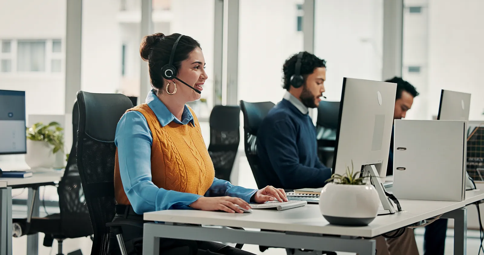 Customer service representative on a headset call in an office